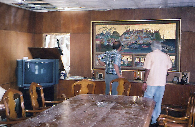 Ismeth Rahim and Michael Anthonisz, both renowned artists familiar with the work of Donald Friend, assessing the damage